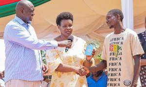 A member of the Pemba community receives his passport