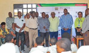 The Deputy Head teacher for Magarini Secondary school welcomes the State Department's team at the ID registration drive