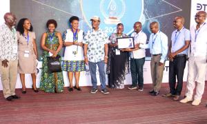 Director General of Immigration, Evelyn Cheluget, and team proudly raise their awards for Best Collaborative Digital Public Sector Initiative (ETA), State Department of the Year in Digital Innovation, and 1st Runner-Up in Overall Digital Transformation."